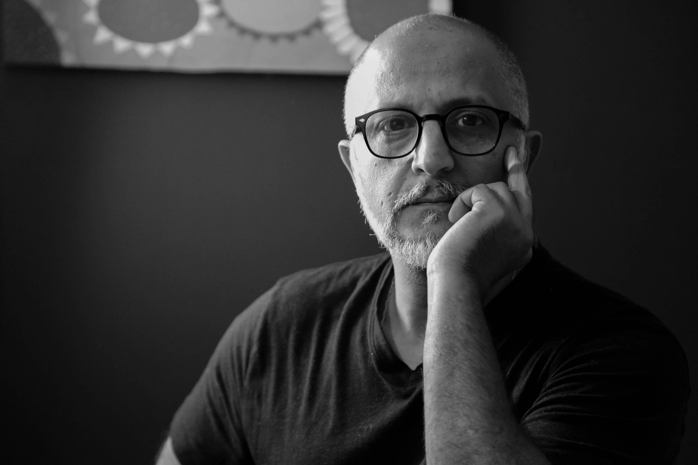 Portrait en noir et blanc de Mohammed Marouazi, la main sur la joue